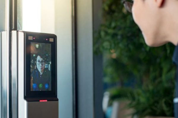 Pessoa utilizando sistema de vídeo e reconhecimento facial em portaria remota da Stratum Segurança Inteligente.